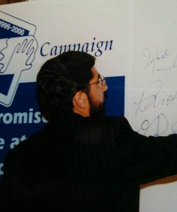 Iqbal Sacranie signs the Clean Slate promise